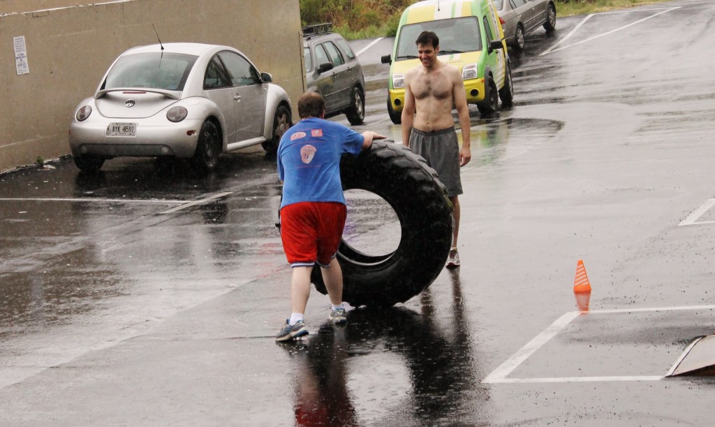 Smiles from Axel flippin' tires in the rain. Saturday's Partner WOD