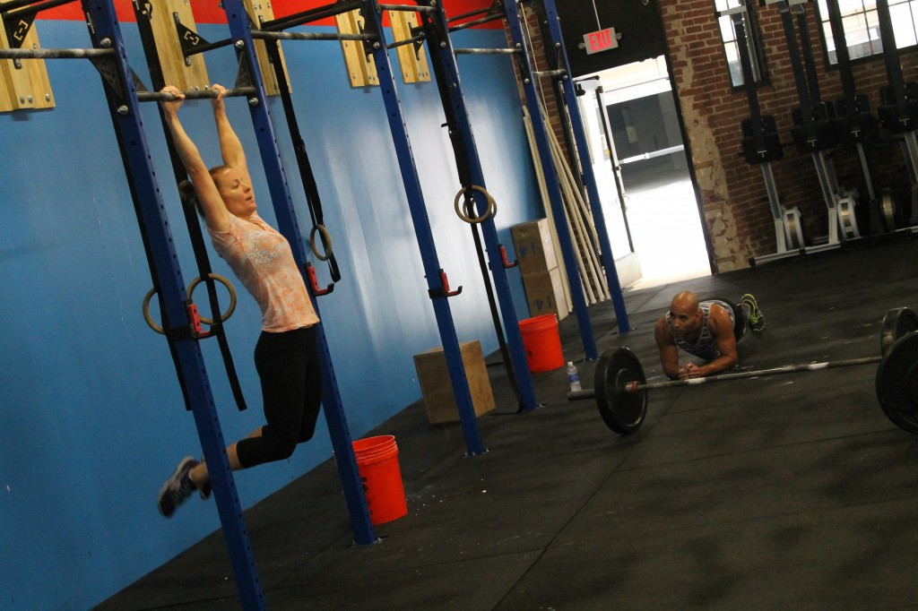 Coach Kelly on a partner WOD with pullups & planks