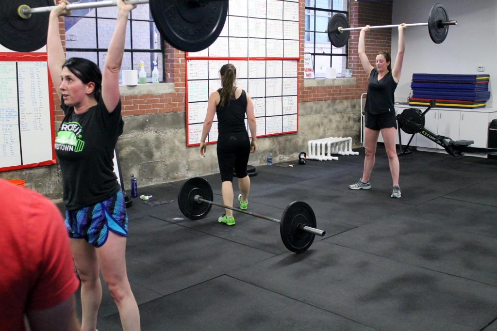 Top of the thruster. Liz and Gracie mirroring reps.